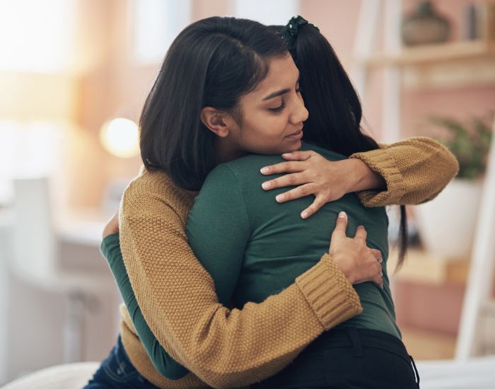 stock image of two women supporting each other