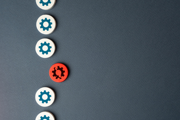 Six round tokens with gear icons, five white with blue gears and one red with a black gear, arranged vertically on a dark surface.