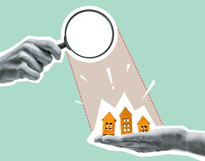 Stock art of hand holding miniature buildings